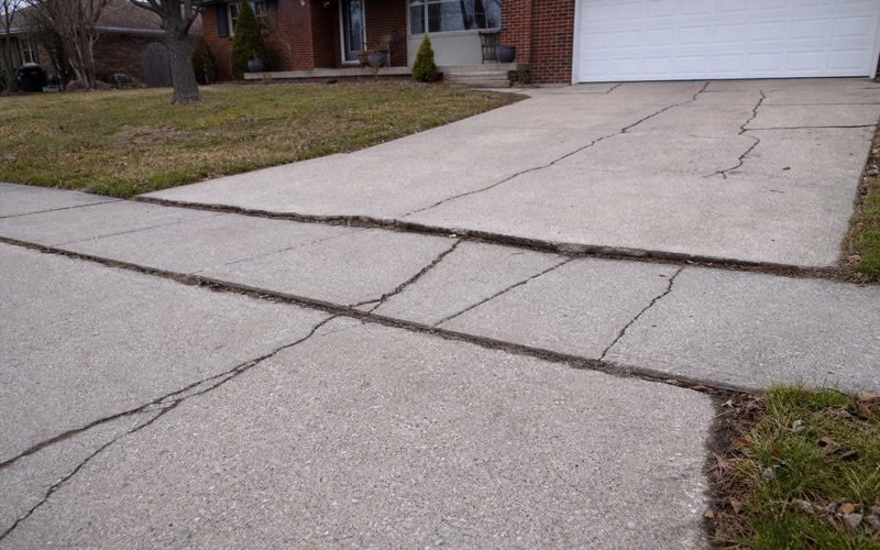Cracked residential driveway and sidewalk